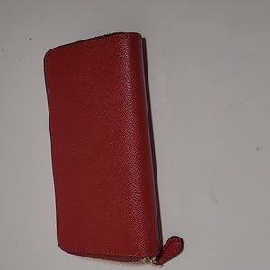 Coach wallet. Red with outside ID pocket with 12 card holders. Zippered middle.